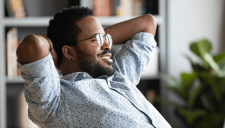 avoiding over complicating comp plans, man sitting at desk with arms behind his head