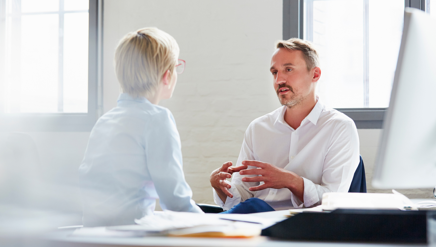direct sales model, two people talking across a work table