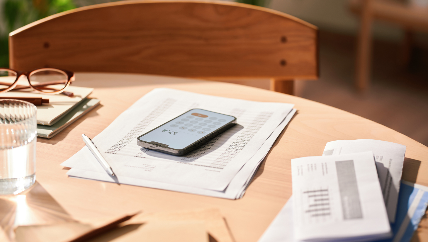 Navigating sales compensation compliance best practices, image of papers and calculator on desk