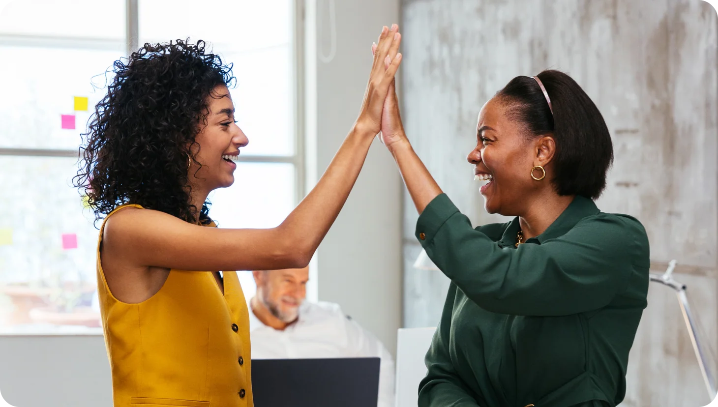 two women high fiving